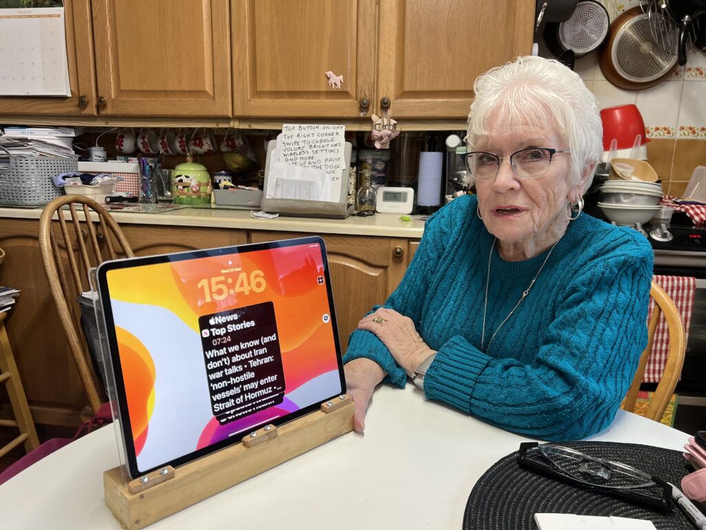 a woman at home in her kitchen with a digital tablet. 